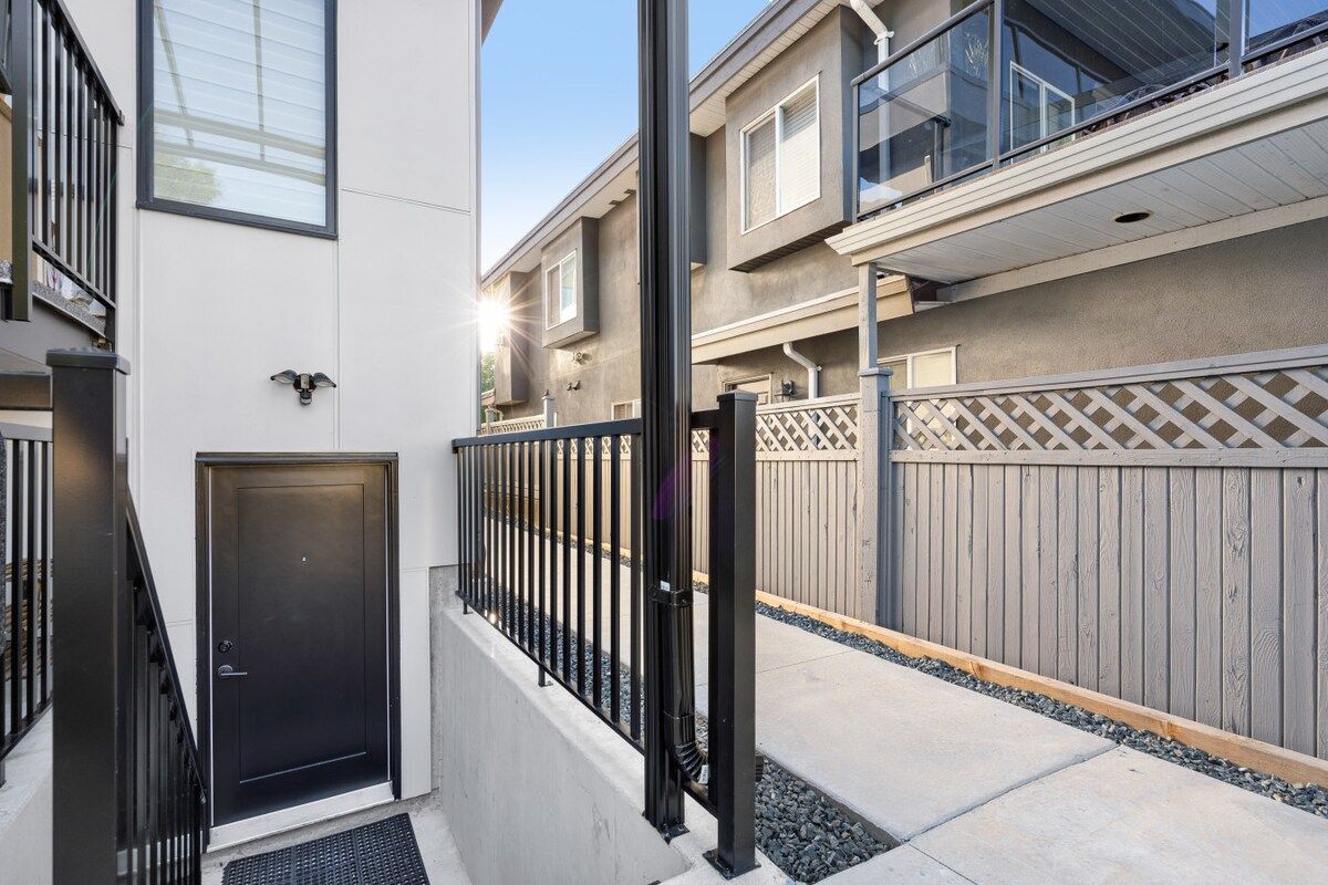 A residential building with a gated entrance, a door, and a balcony.