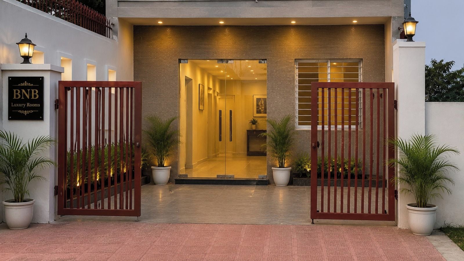 A hotel entrance with a sign reading 'BNB Luxury Rooms,' a gated entrance, and potted plants.