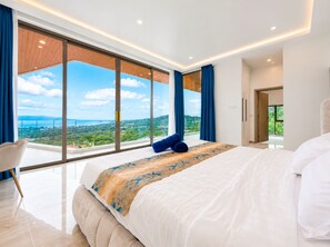 Une chambre moderne avec un grand lit, une vue sur le paysage et un balcon.