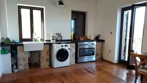 A compact kitchen with a washing machine, oven, and a sink. - Isolated luxury villa with pool, 30 mins to sea, 2 km to village shops tavernas (messenia)