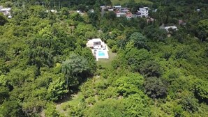 A large, isolated house surrounded by dense forest, with a swimming pool and a small garden. - 3 Bedroom Country Villa with Private Pool (El Bonao)