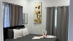 A bedroom with a bed, a ceiling fan, a painting, and curtains. - 3 Bedroom Country Villa with Private Pool (El Bonao)