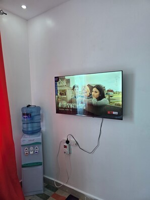 A television mounted on a wall displaying the title 'My Life with Walter Boys.' - Matunda homes 
Cozy.Classy.Beautiful (Mombasa)