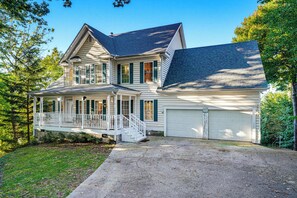 A two-story house with a front porch, a garage, and a driveway. - New Listing, Hot Tub, Arcade Games, Free Attractions, Mountain Views (Gatlinburg)