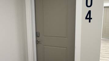 A closed door with a number '304' on the wall beside it.
