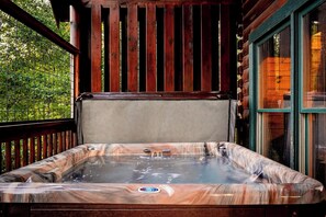 A hot tub with a control panel, surrounded by wooden railings and a glass door. - New Listing, Hot Tub, Game Room, Free Attractions (Sevierville)