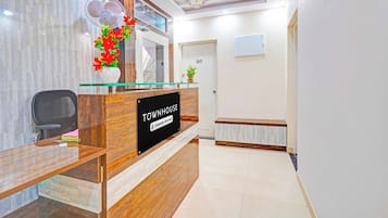 A reception desk with a sign indicating it's a company-serviced townhouse.