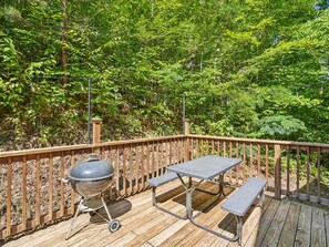 A wooden deck with a barbecue grill and picnic table. - Bear Crest | Hot Tub, Pet-Friendly (Gatlinburg)