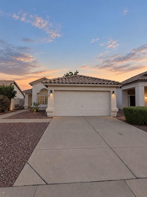 A residential house with a garage, driveway, and a well-maintained lawn. - Pool, Tub & Mini Golf |SF Stadium, Westgate, more (Glendale)