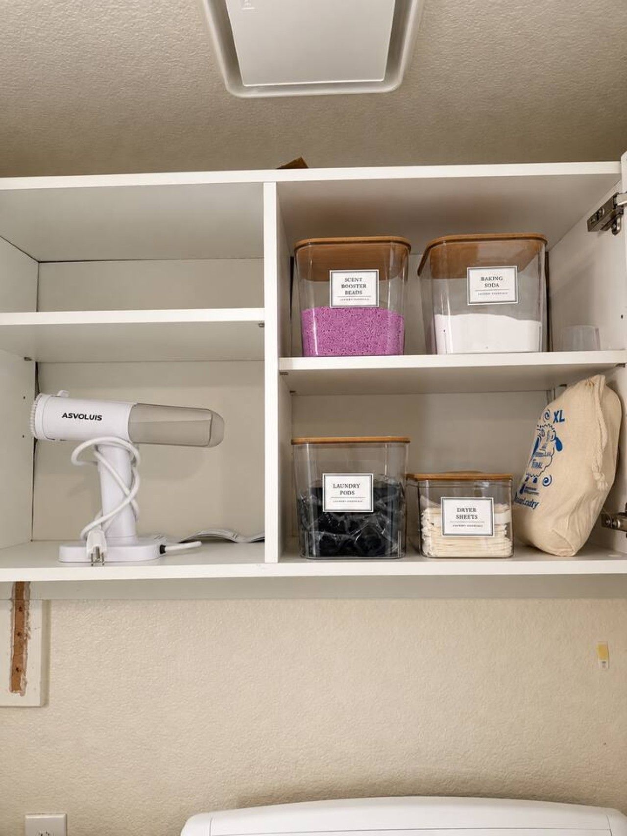 A storage area with shelves containing various items like a hairdryer, scented beads, laundry pods, and baking soda.