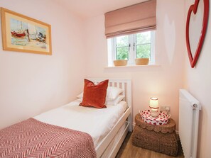 A bedroom with a single bed, a window with a view, a bedside table with a lamp, and a painting on the wall. - Little Red Barn (Shrewsbury)