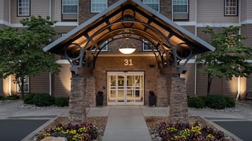 A building entrance with a stone facade, a number '31' above the door, and a covered walkway.
