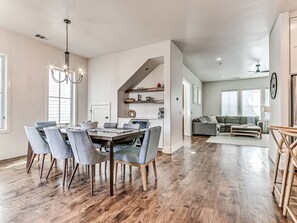 A spacious living area with a dining table, chairs, and a sofa. - Beautiful 4 Bed 2.5 Bath Home in Wheeler District (Oklahoma City)