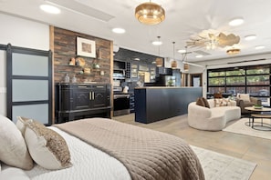 A modern interior with a kitchen, dining area, and living space. - The Back Nine | King Bed, Fireplace & Fenced Yard (Fort Collins)