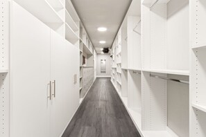 A spacious walk-in closet with custom shelving and hanging rods offers you plenty of room to unpack and settle in. - The Back Nine | King Bed, Fireplace & Fenced Yard (Fort Collins)