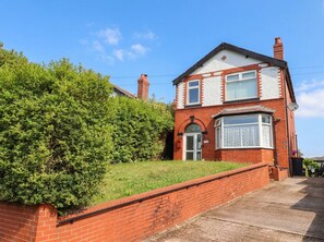 A two-story brick house with a bay window, a front door, and a small garden area. - 29 Brynford (Ellesmere Port)