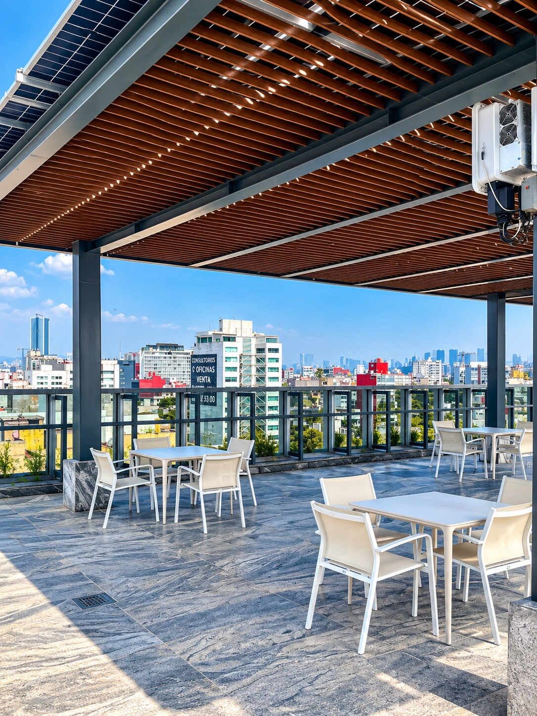 An outdoor seating area with tables and chairs, a wooden ceiling, and a cityscape view.