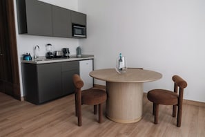 A modern kitchen with a microwave, coffee maker, and blender on the counter. - Condesa Residence - Roma Luxury Suite 507 (Mexico City)