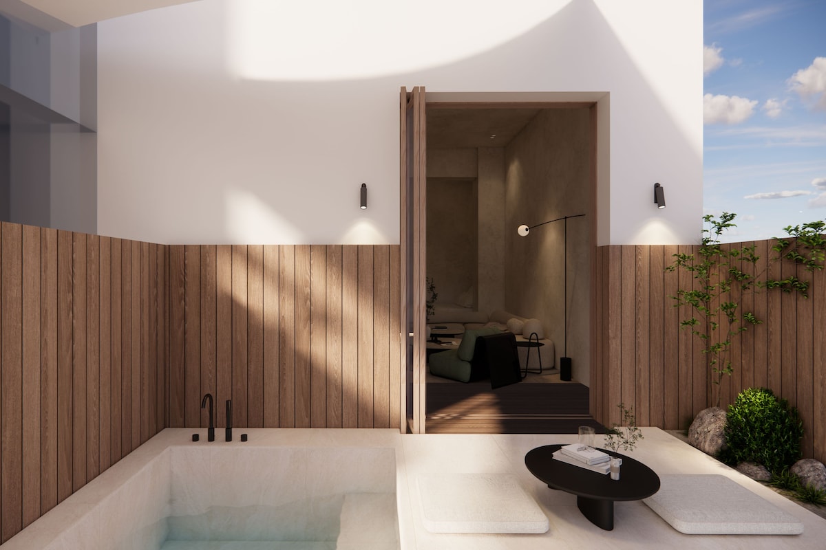 A modern outdoor bathroom with a hot tub, wooden paneling, and a view into the adjacent living area.