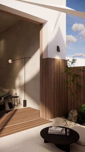 A modern outdoor living space with a sofa, coffee table, and a lamp. - Hotel COTA (Busan)