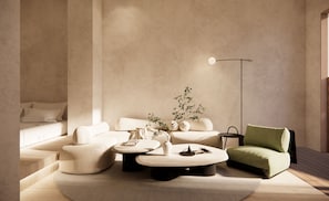 A modern living room with a sofa, armchairs, a coffee table, and a floor lamp. - Hotel COTA (Busan)