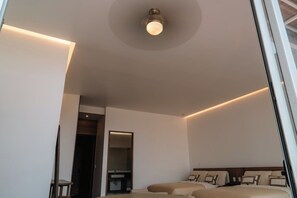 A modern hotel room with a bed, bedside tables, and a ceiling light fixture. - Condesa Residence - Roma Luxury Suite 605 (Mexico City)