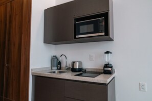 A kitchen with a microwave, kettle, toaster, and blender on the counter. - Condesa Residence - Roma Luxury Suite 303 (Ciudad de México)