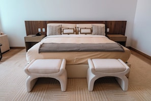 A hotel room with a large bed, two bedside tables, a nightstand, and two matching armchairs. - Condesa Residence - Roma Luxury Suite 604 (Mexico City)