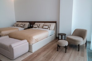 A hotel room with two beds, a sofa, a chair, and a small table. - Condesa Residence - Roma Luxury Suite  305 (Ciudad de México)