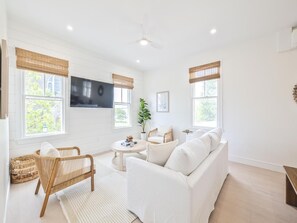 Enjoy a cozy living room filled with natural light, perfect for relaxation and entertainment. - Modern Condo Above Boutiques + Beach Nearby (Cape May)
