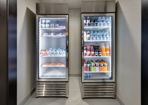 Two refrigerated display cases with snacks, beverages, and dairy products.