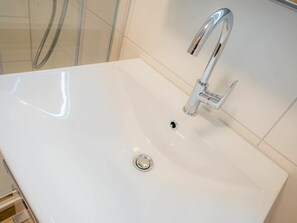 A white bathroom sink with a chrome faucet and a drain. - 6 in the House at Blanker-hans-weg 5 (St. Peter-Ording)