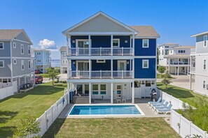 A two-story residential building with a pool and outdoor seating area. - Corolla Cottage: Semi-Soundfront | Pet Friendly (Corolla)