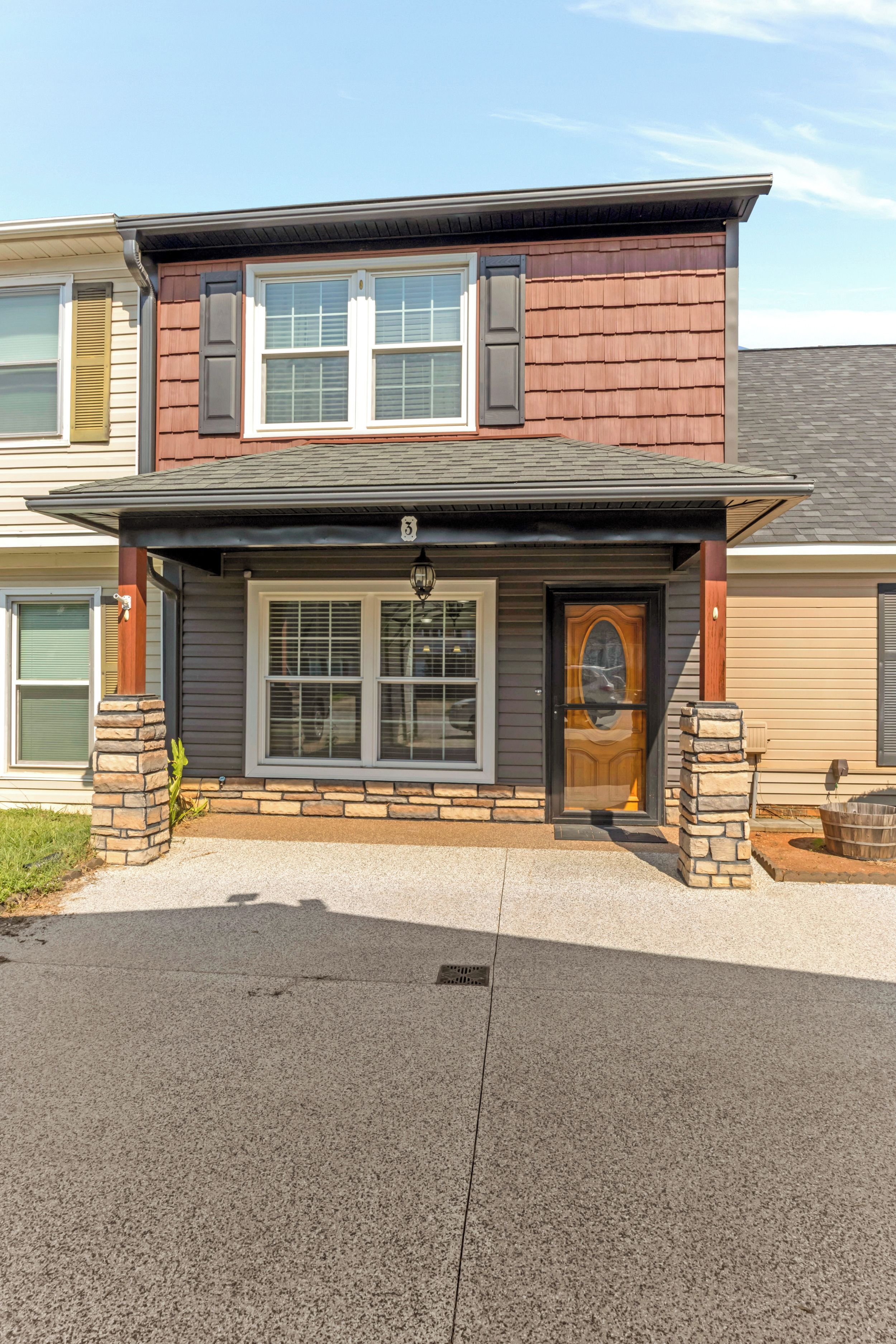 A two-story house with a front porch, a mailbox, and a number '3' sign above the door.