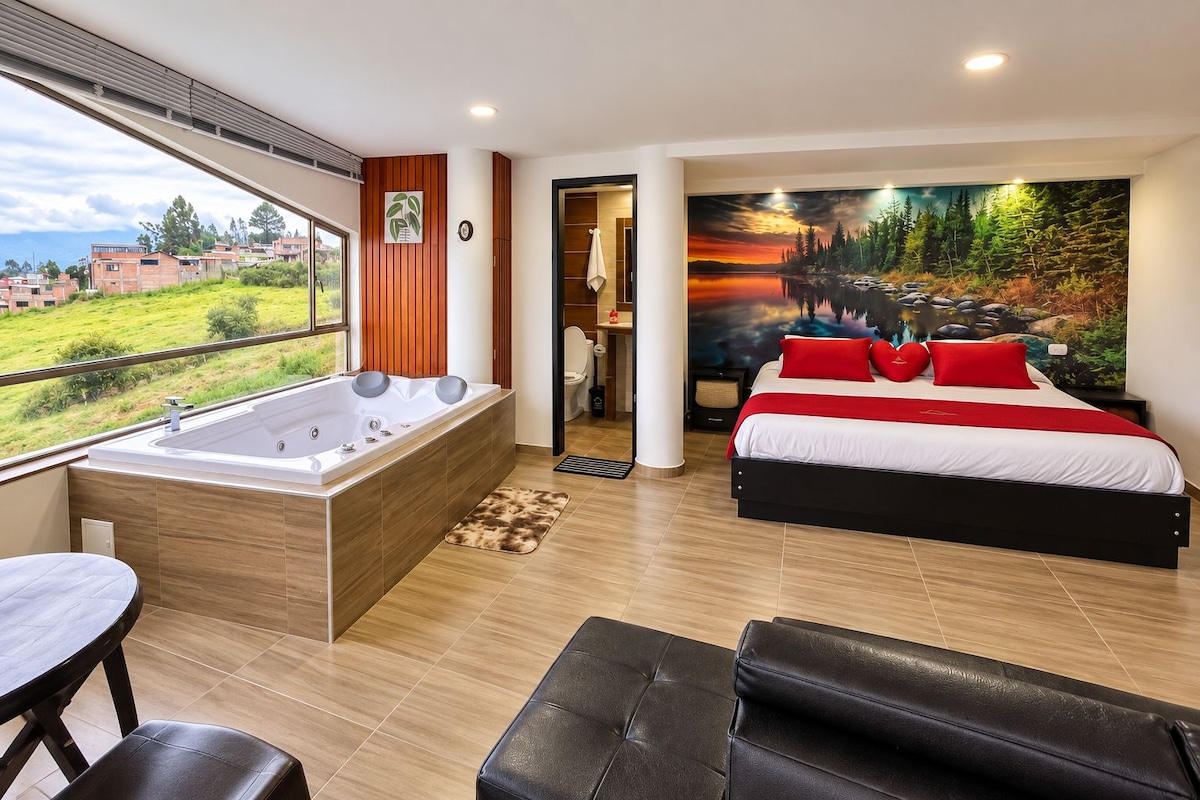 A modern bedroom with a large bed, a bathtub, and a view of a green landscape.