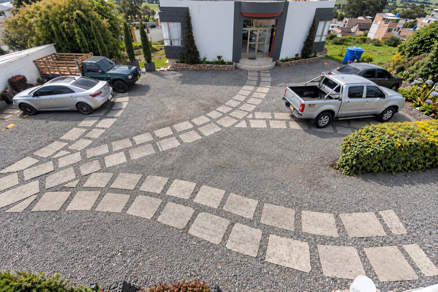 A parking area with a paved walkway leading to a building entrance.