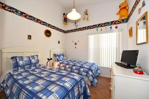 A bedroom with two beds, a desk, a computer, and various wall decorations. - 4 bedroom accommodation in Kissimmee (Kissimmee)