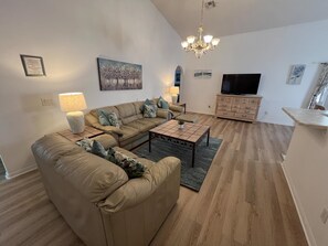A living room with a sofa, coffee table, and TV. - 4 bedroom accommodation in Kissimmee (Kissimmee)