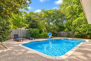 A backyard with a swimming pool, a basketball hoop, and two lounge chairs. - Swim by Day~Soak by Night~Fenced Yard~Poolside BBQ (San Antonio)