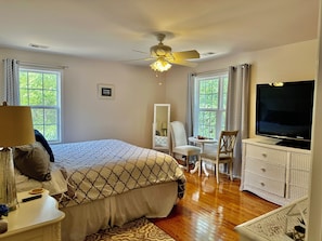 A bedroom with a bed, a television, a desk, and a chair. - Perrydise Lakehouse with Pool, Hot Tub & Sunset Views (Shelby)