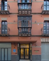 A multi-story building with a ground-level entrance, a visible sign for 'Casa Candida,' and a fire hydrant on the sidewalk.