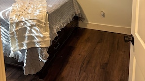 A bedroom with a bed, a window with blinds, a ceiling fan, and a wall-mounted picture. - Downtown Bryan Apt - Walk to Everything (Bryan)