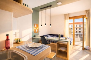 A compact room with a kitchenette, a dining area, and a balcony with a view. - Kley Paris-Saint-Ouen (Saint-Ouen-sur-Seine)