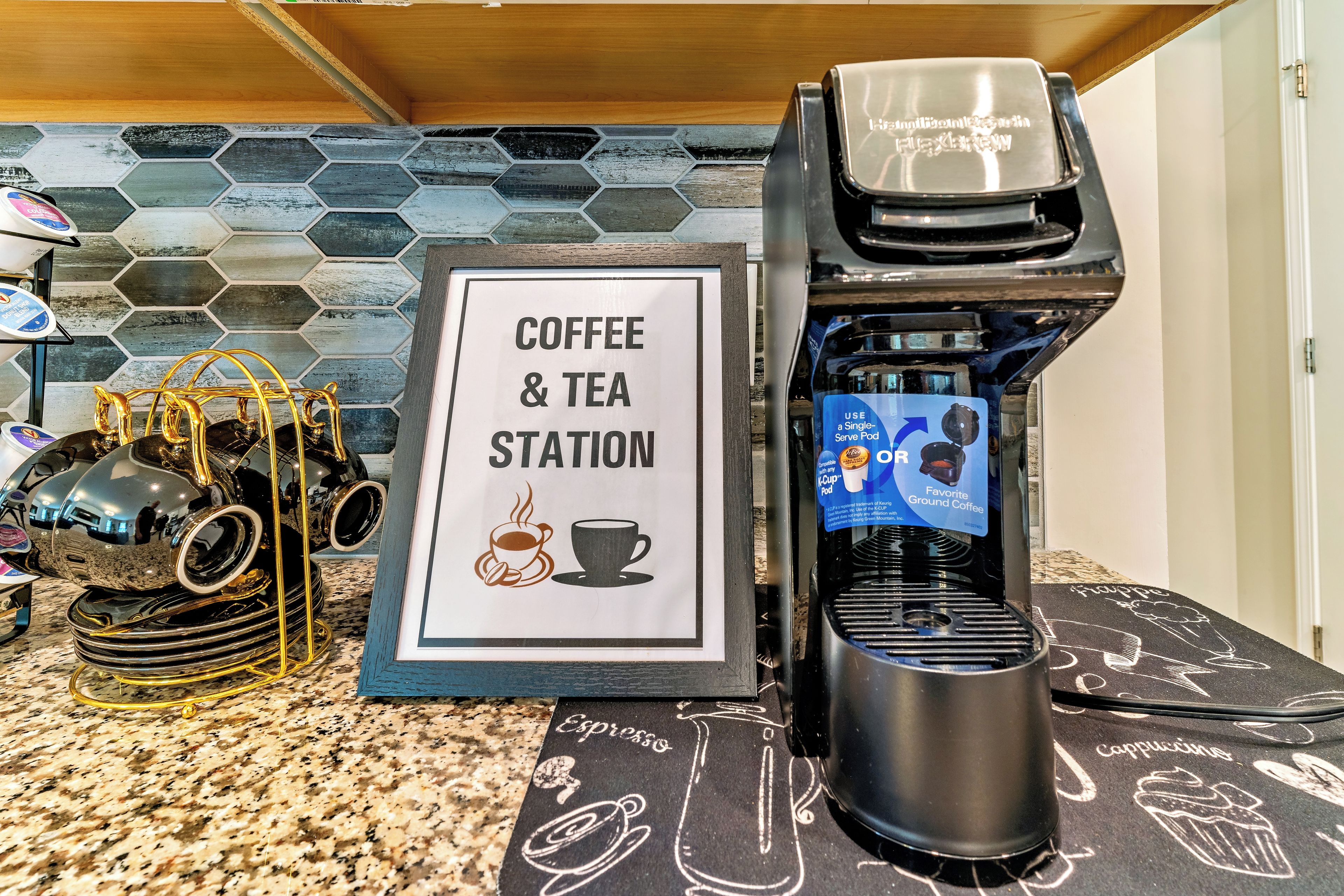 A coffee and tea station with a branded coffee maker and a sign indicating the service.