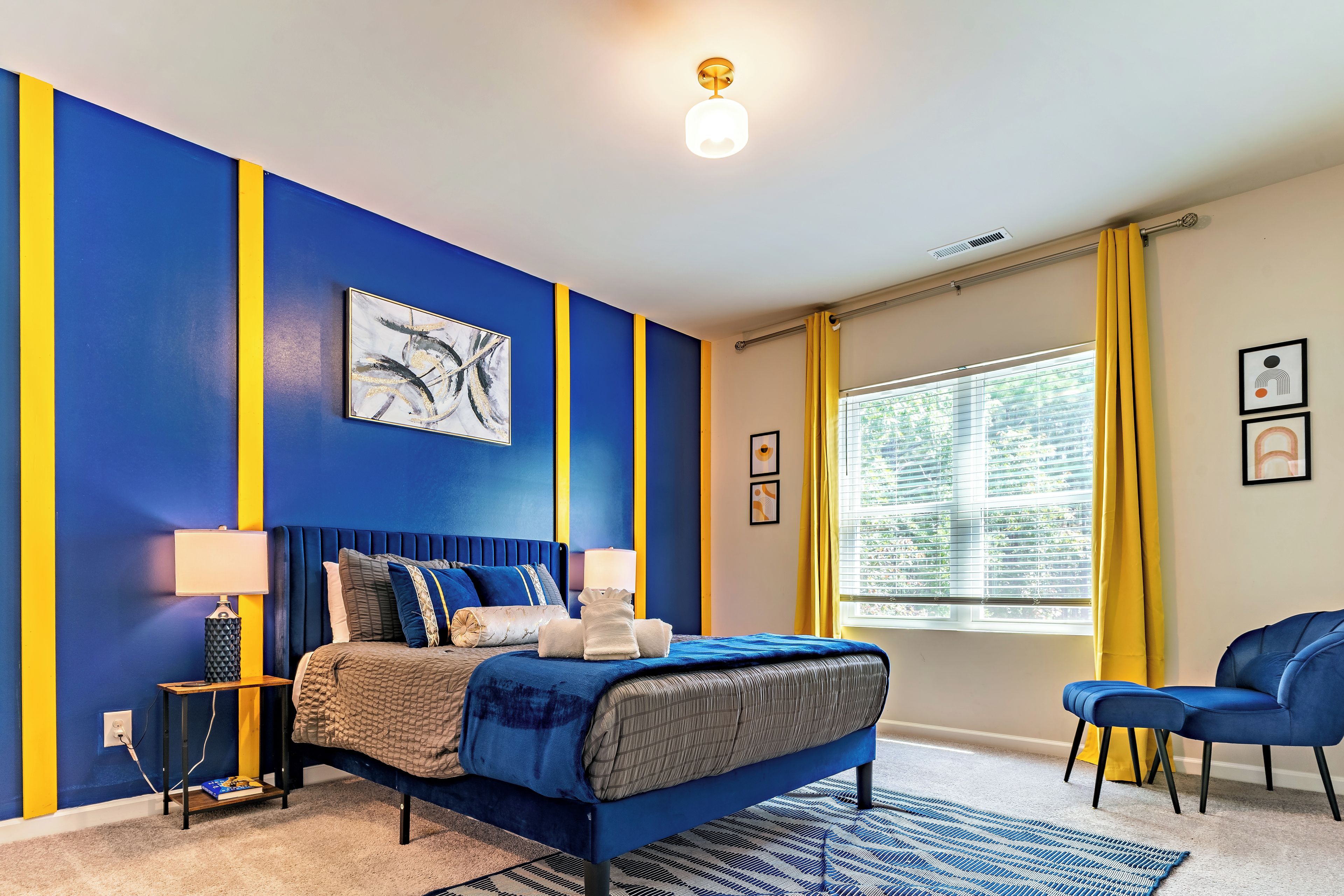 A bedroom with a bed, bedside tables, a chair, and a window with curtains.
