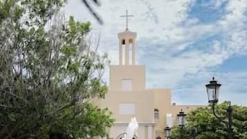 A fountain in the foreground with a church in the background.
