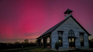 A white church with a steeple, large windows, and a porch under a twilight sky. - Quaint Cabin on 30 acres in Springfield (Springfield)
