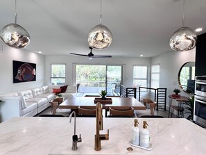A modern kitchen with a marble countertop, stainless steel appliances, and pendant lighting. - Riverfront Retreat- Heated POOL- Heart of Tampa (Tampa)