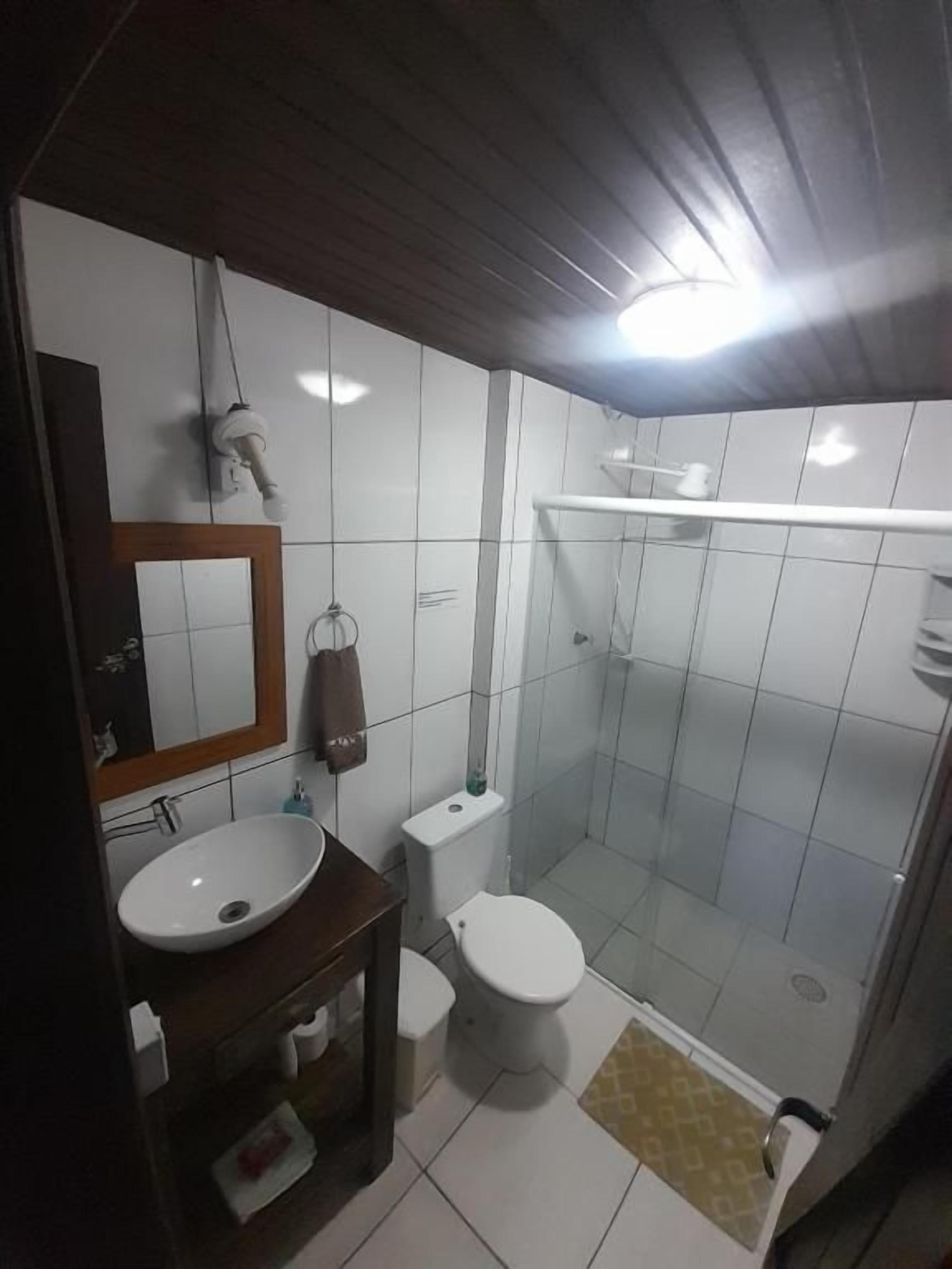 A bathroom with a sink, toilet, and shower.