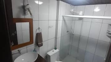 A bathroom with a sink, toilet, and shower.